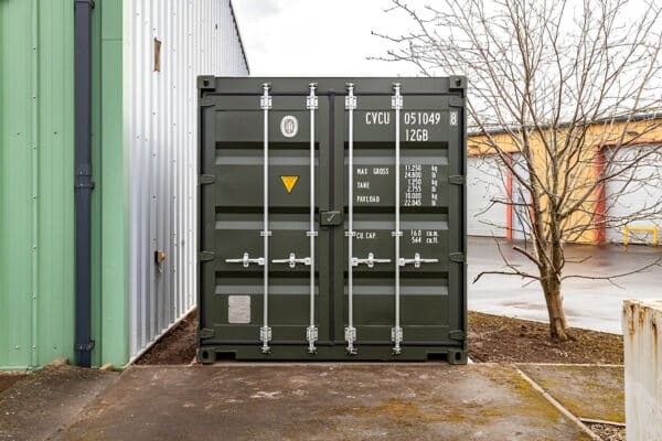 Green steel cargo container with exterior hinged double doors